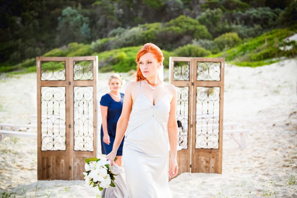 Red haired bride on beach